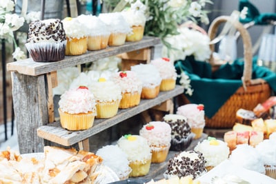 Cupcakes on wooden shelf next to the basket
